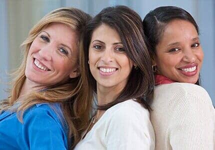 Portrait of three women smiling - Women's Health Clinic in Naples, FL
