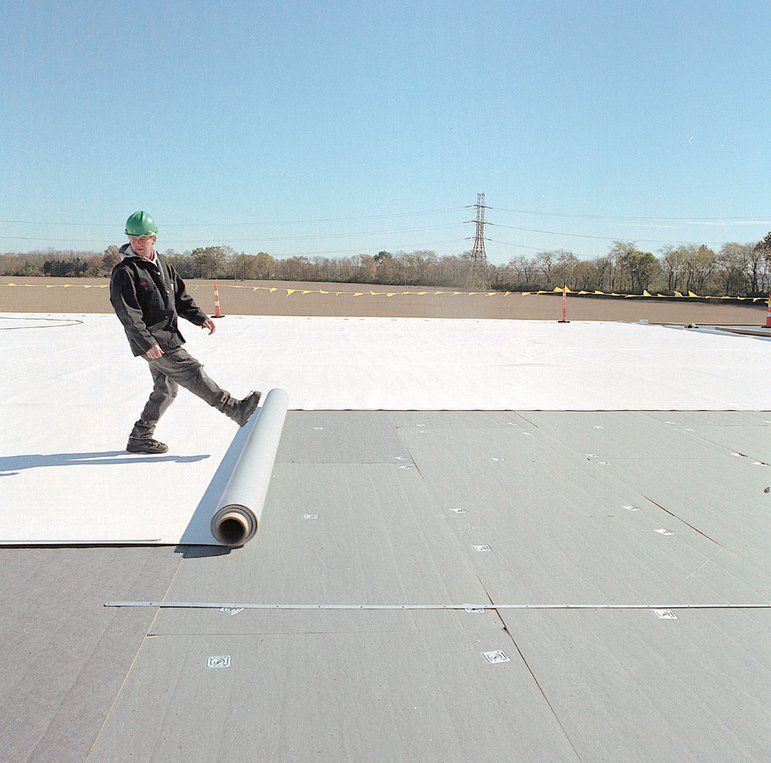 TPO Vinyl Roofing - rolling out roof