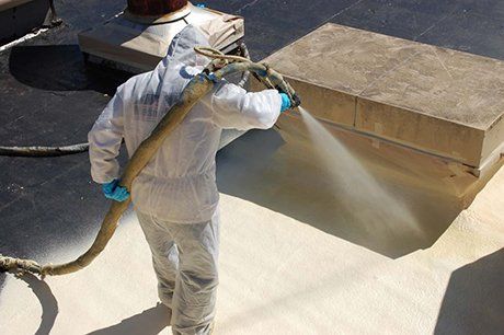 Man Spraying Foam On Roof