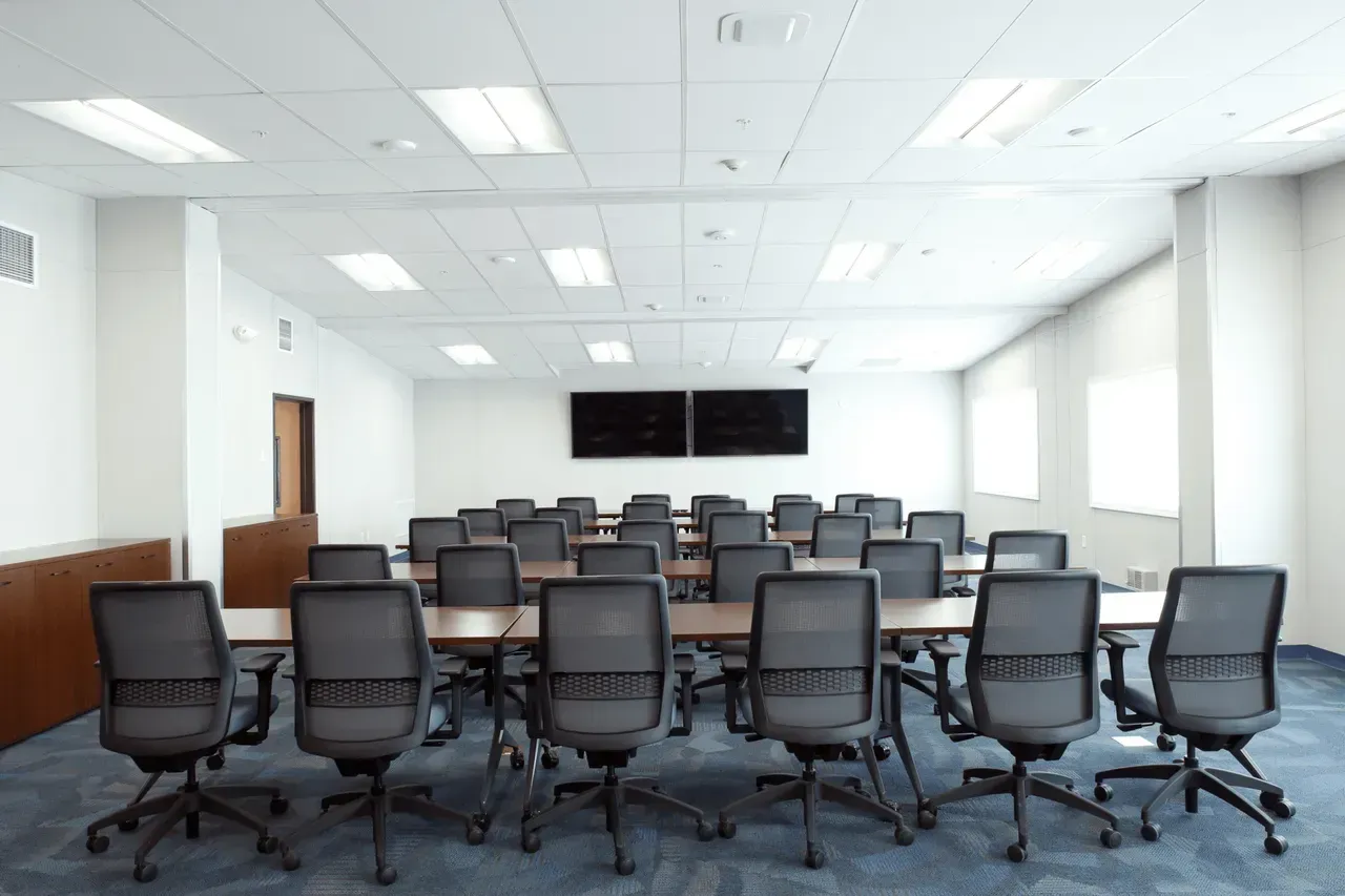 A conference room with tables and chairs in it