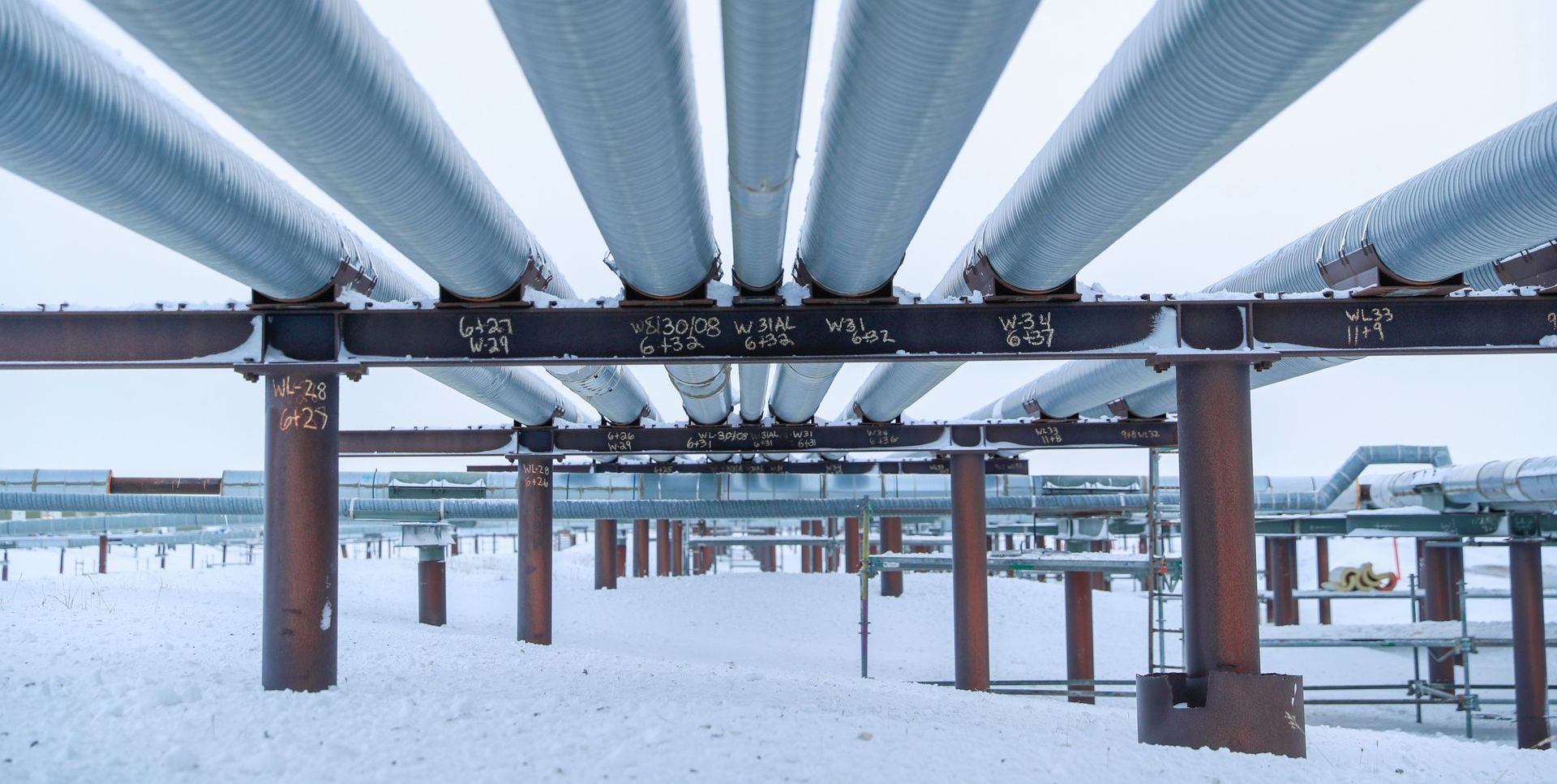 A bunch of pipes are connected to each other in the snow.