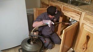 Man Draining The Toilet — Drain Cleaning in Milan, IL