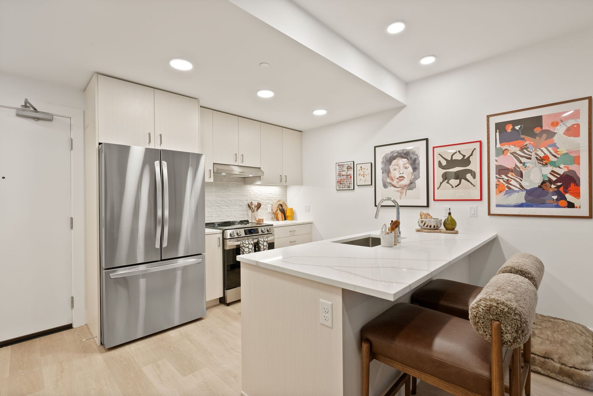 Spacious living room with sofa,dining table, and large windows.