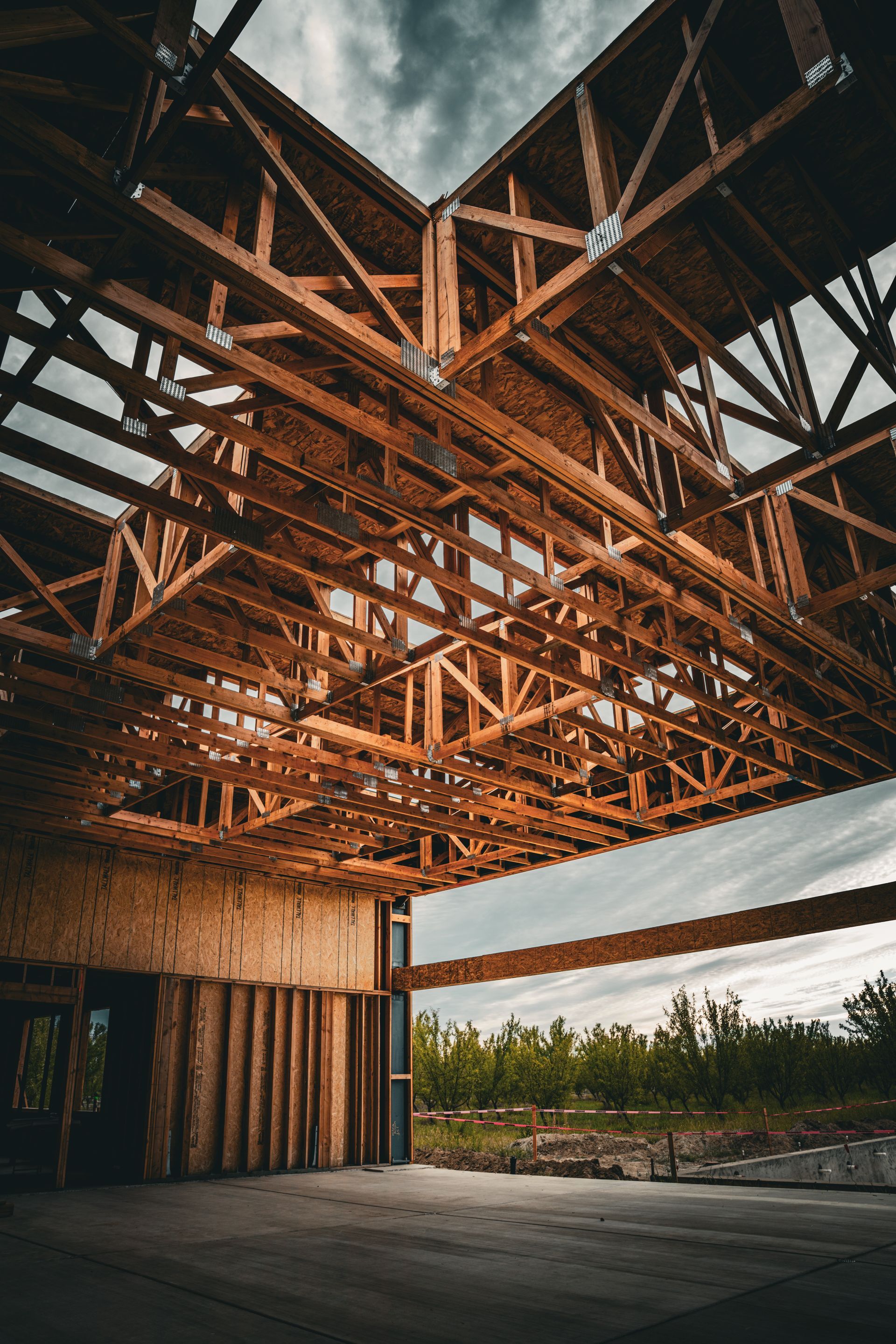 Modern interior with marble wall, wooden stairs, and a glossy gray floor under a slanted ceiling