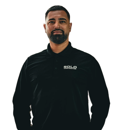 Man in black jacket standing against a white background