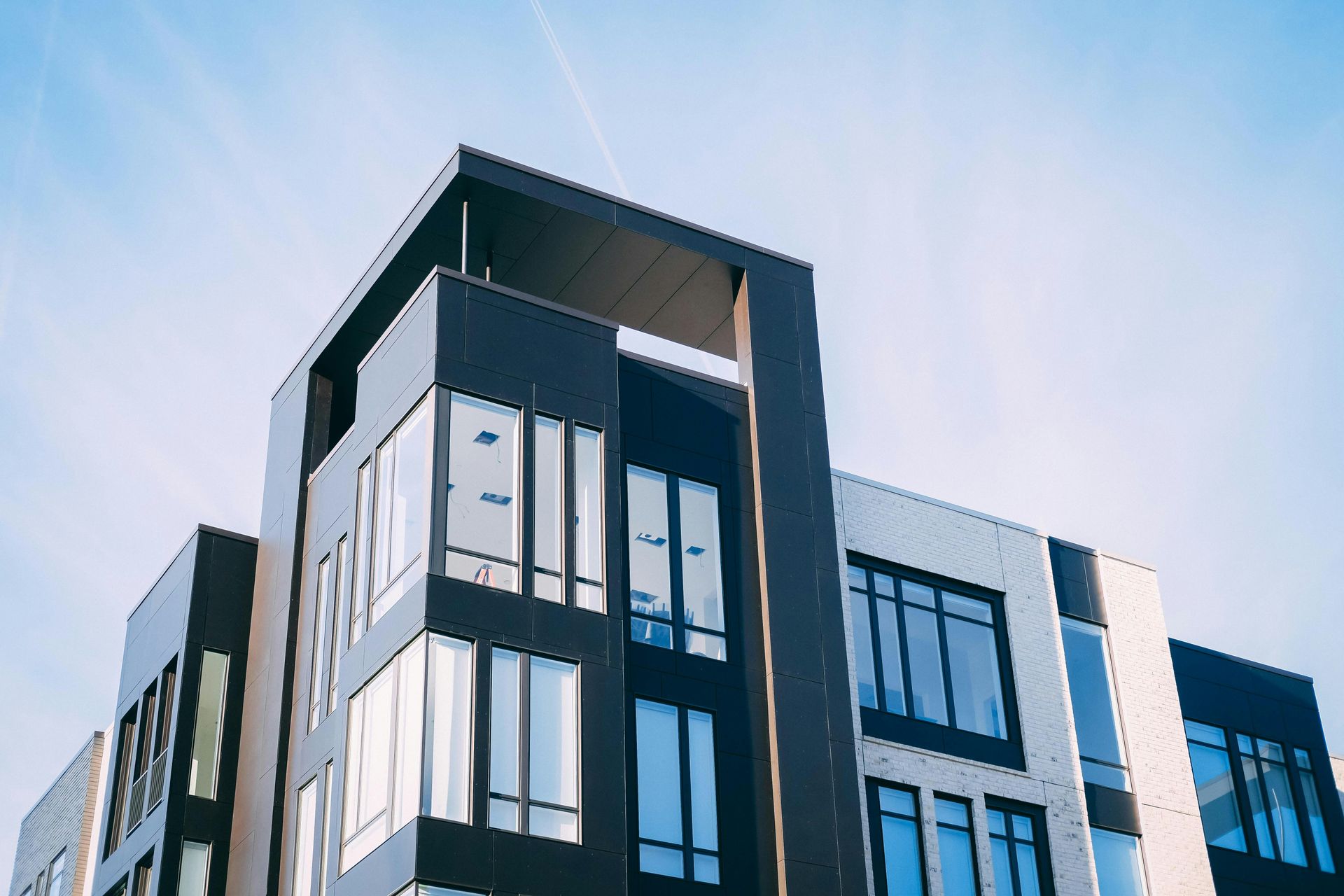 Modern black-and-white office building against a blue sky