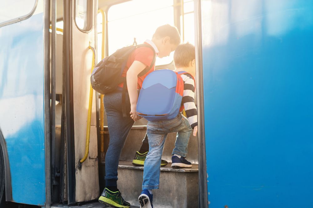 Two Boys Entering Bus — Cotswold Hills, QLD — Robertson's Bus & Coaches