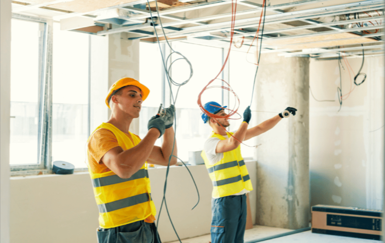 Electrical workers managing cables