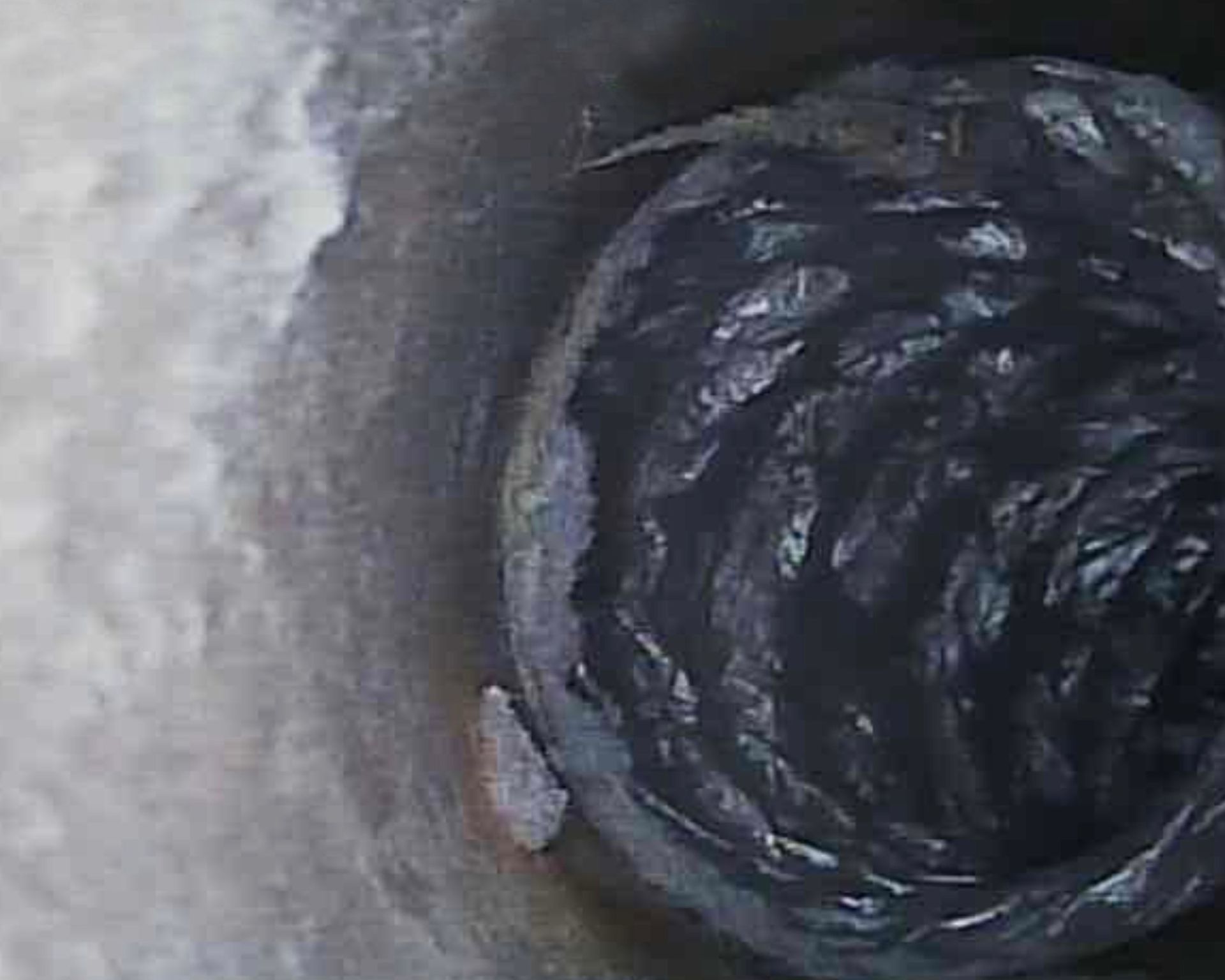 A close up of a black object in a hole.