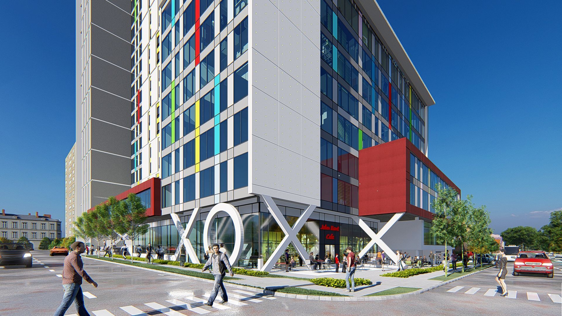 Modern multi-story building with red, blue, and white accents, people walking, crosswalk, sunny day.