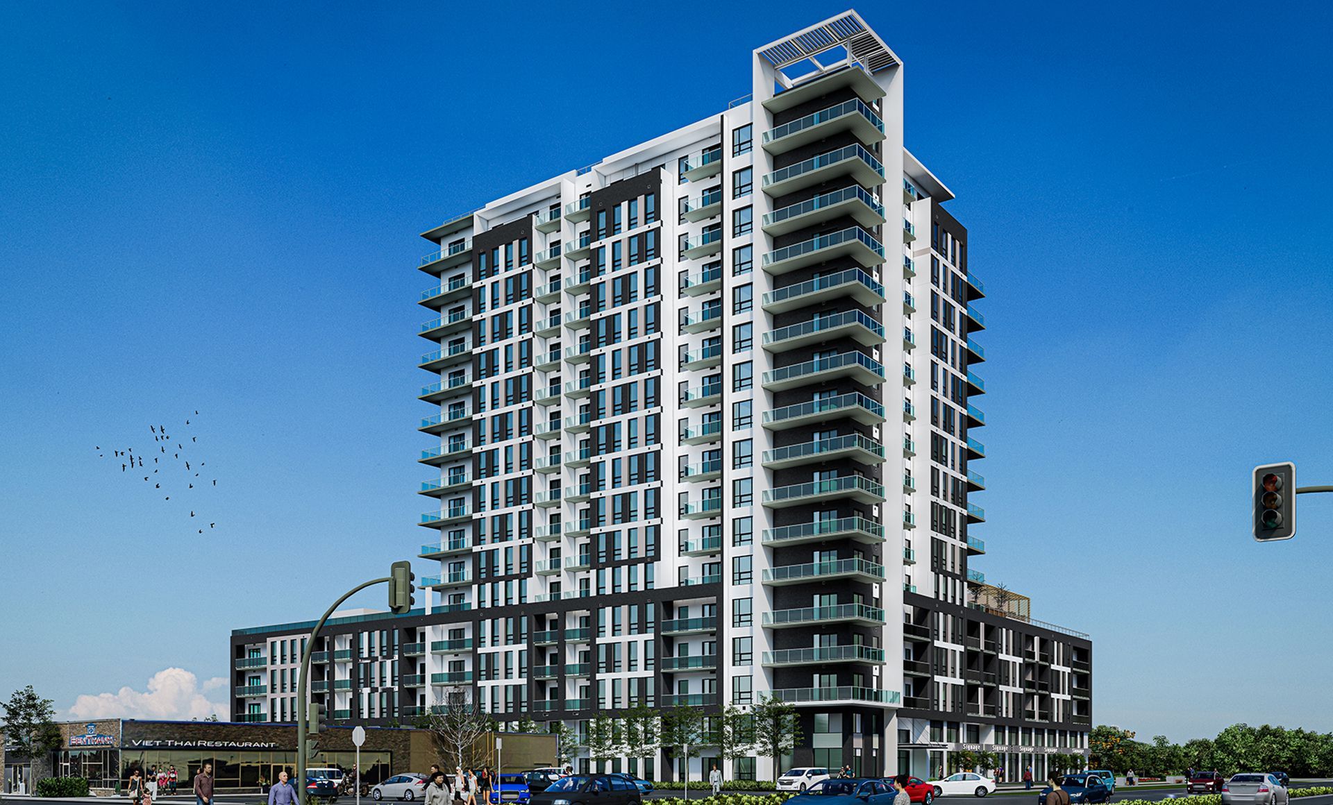 Modern high-rise building with glass windows against a clear blue sky. Cars and pedestrians on the street.