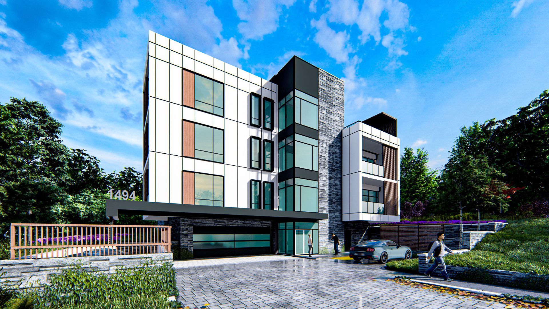 Modern multi-story building with a gray stone facade, windows, and a driveway with people.