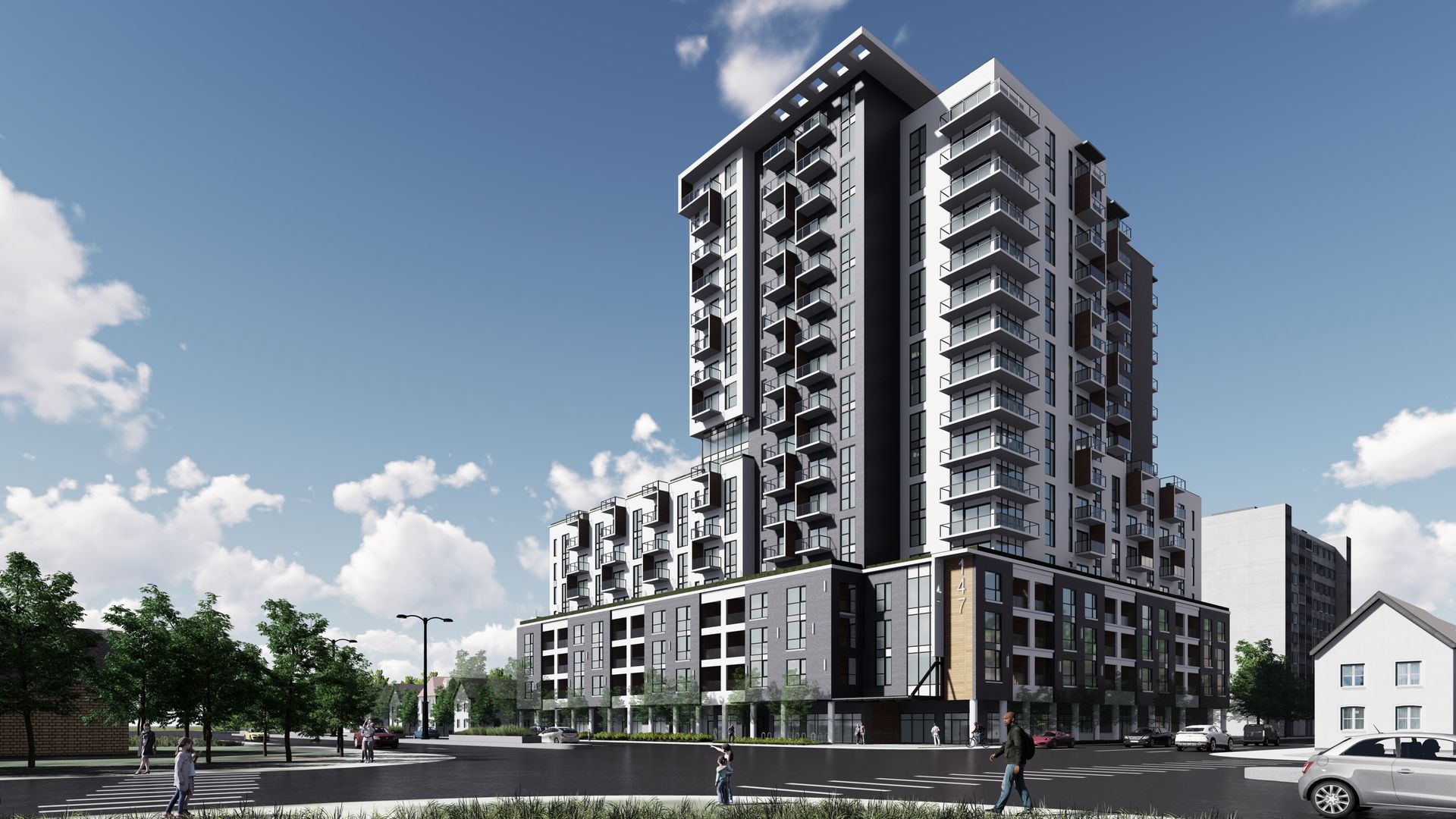 Modern high-rise apartment building with balconies against a blue sky.