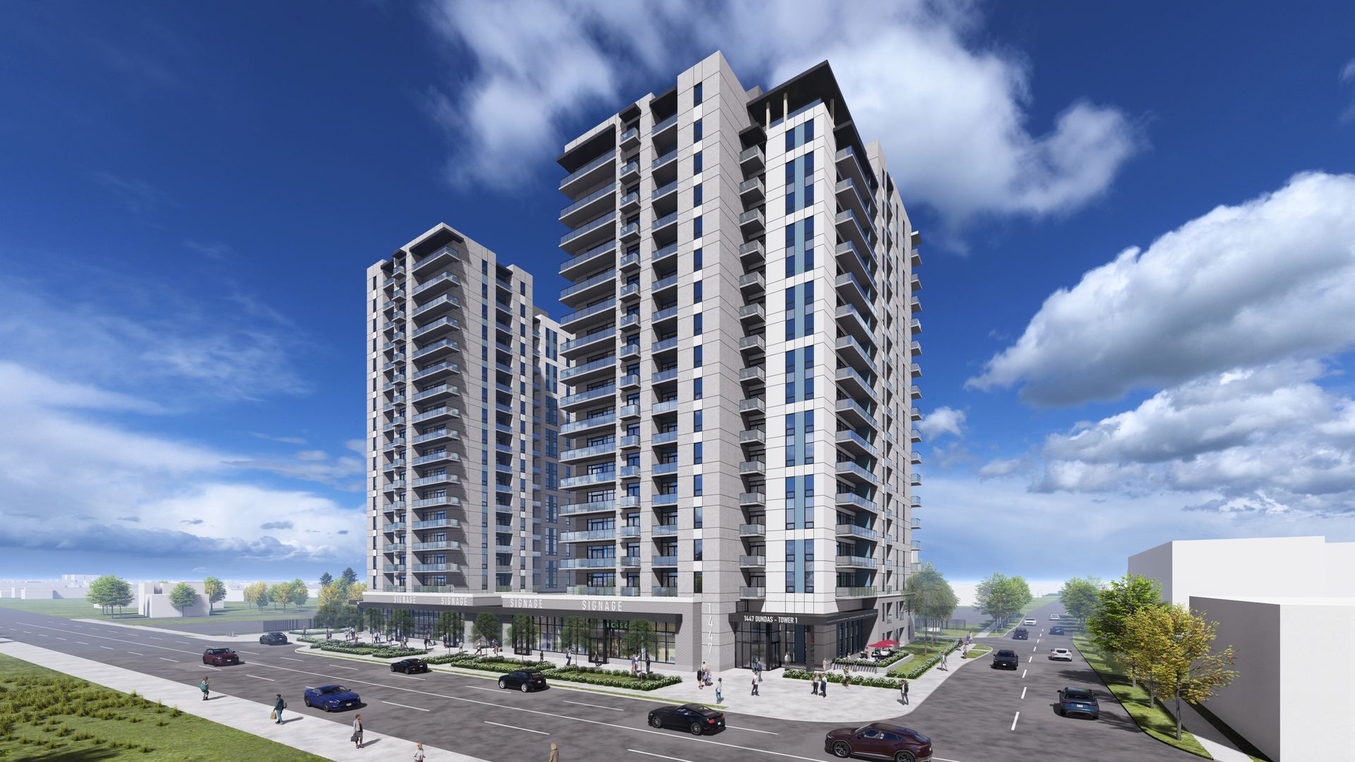 Two high-rise apartment buildings with balconies, light-colored exterior, against a blue sky with clouds; a street with cars.