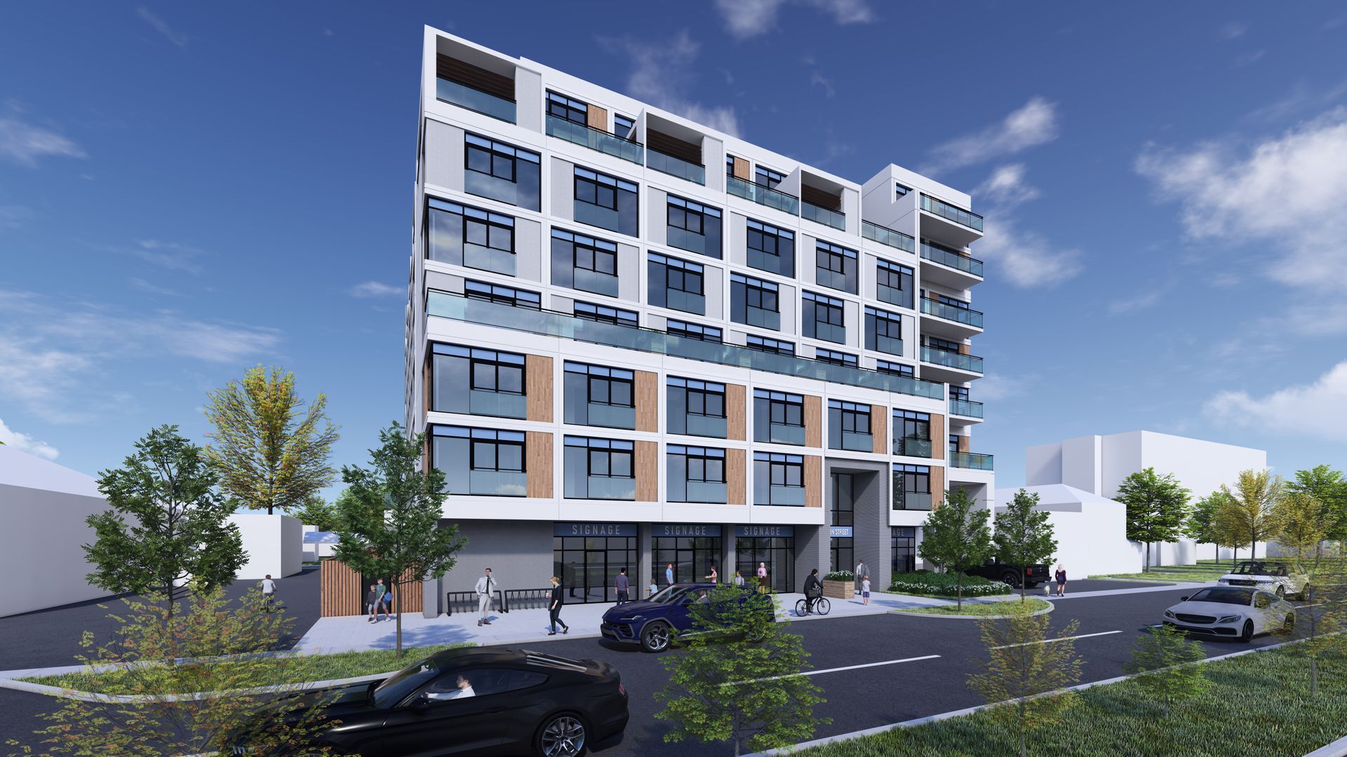 Modern multi-story building with white facade, glass balconies, and street-level shops, blue sky.