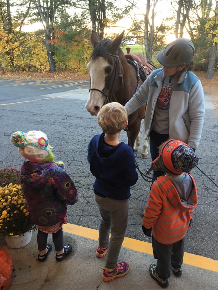 Three children in front of the horse - Child Care Centers in Hollis, NH