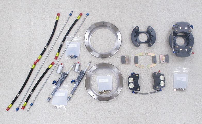 A bunch of brake parts are laid out on a table