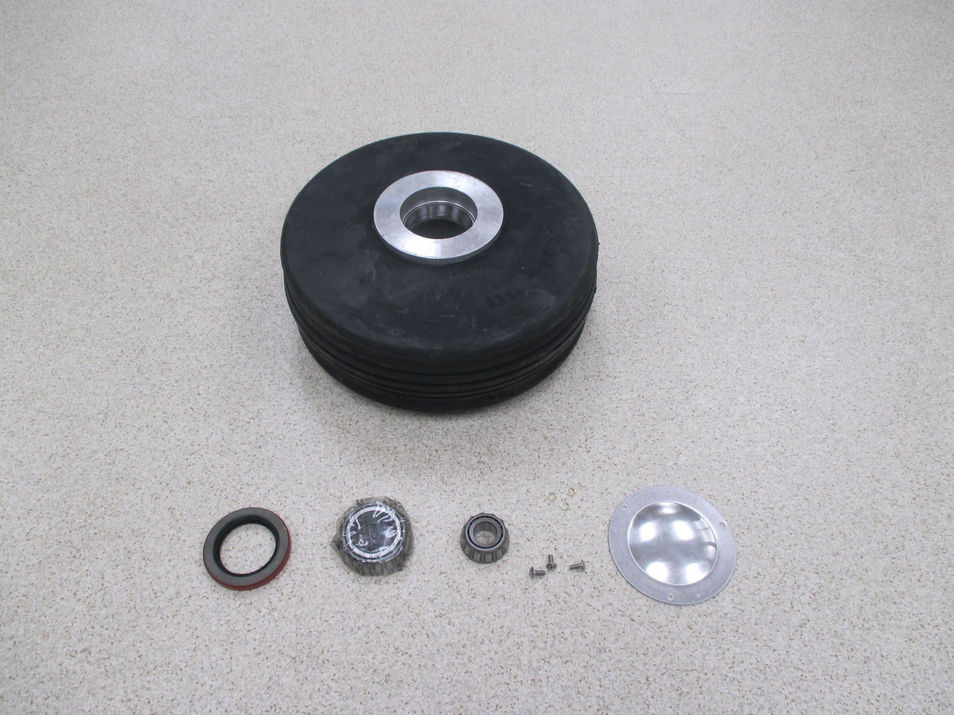 A rubber wheel with nuts and washers on it