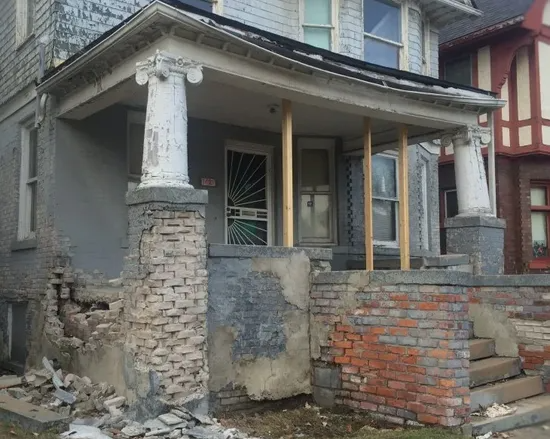 Cracked brick porch steps before repair