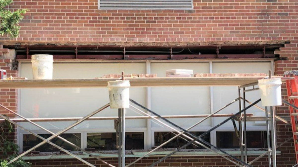 EFD Masonry replacing the steel lintel and repairing the brick façade above windows of Bishop Foley Catholic High School.