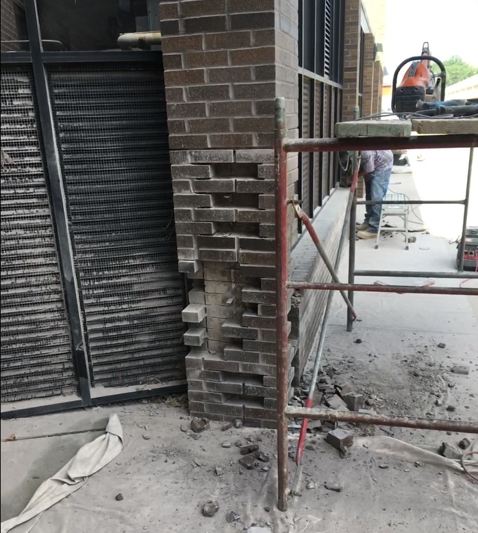 Partially demolished brick column at a store front under EFD Masonry restoration in Oakland County.