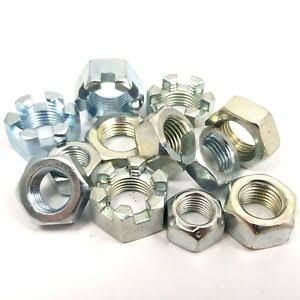 A bunch of nuts are sitting on top of each other on a white surface.