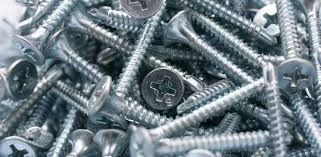 A pile of screws sitting on top of each other on a table.