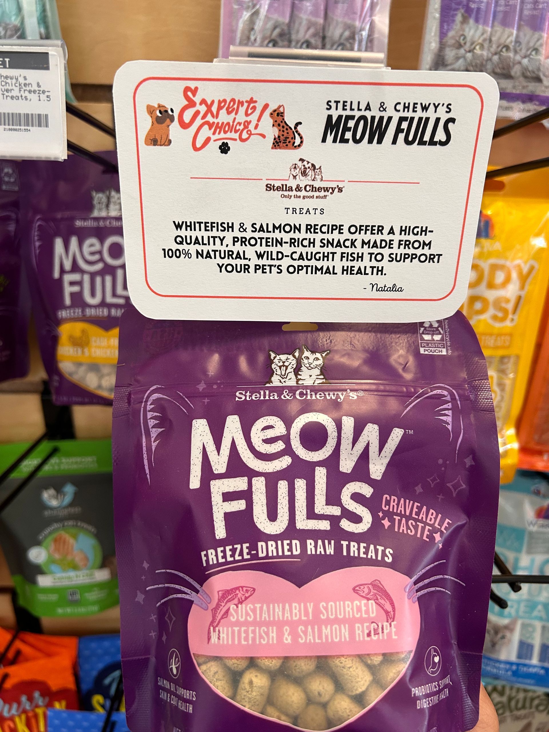 A dog is sitting next to a bunny mascot in front of easter eggs.