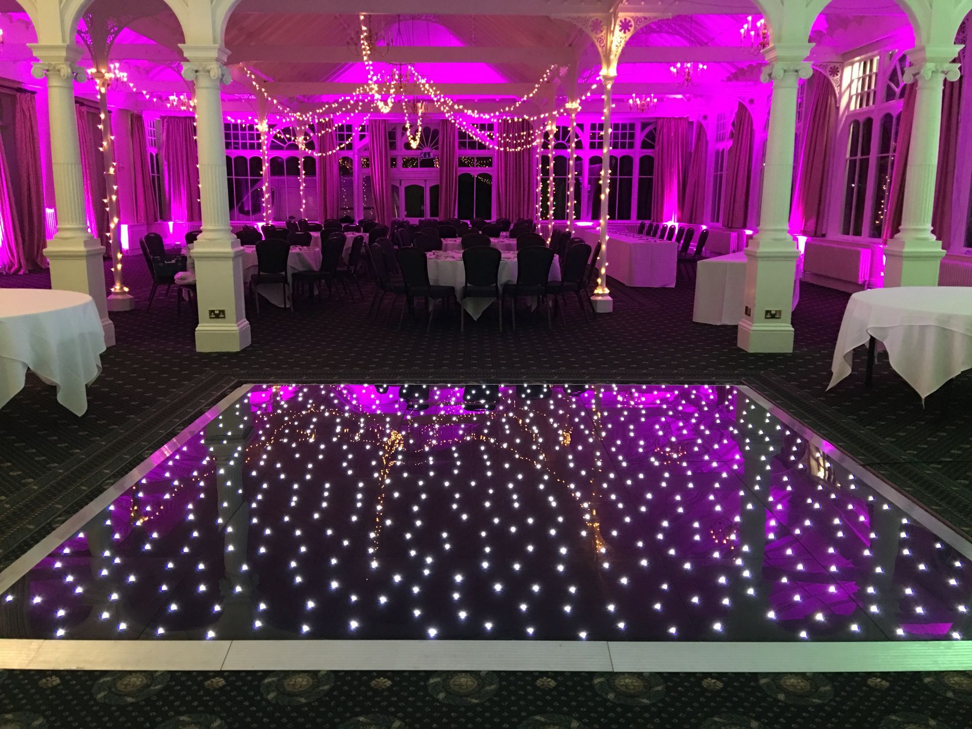 Decor lit with pink lighting. Black base with sparkly white lights for this light up dance floor. Production services and equipment  hire for this event was supplied by Exclusive Entertainments Harrogate,Yorkshire