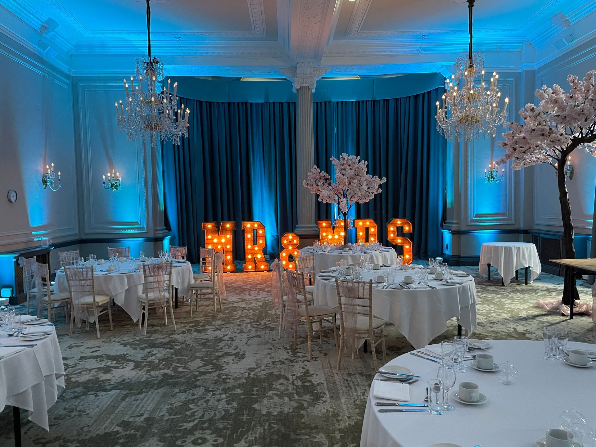 Cool blue and white lighting showcases Mr and Mrs lights at a wedding reception. Decor and Lights from Exclusive Entertainments, Harrogate, Yorkshire