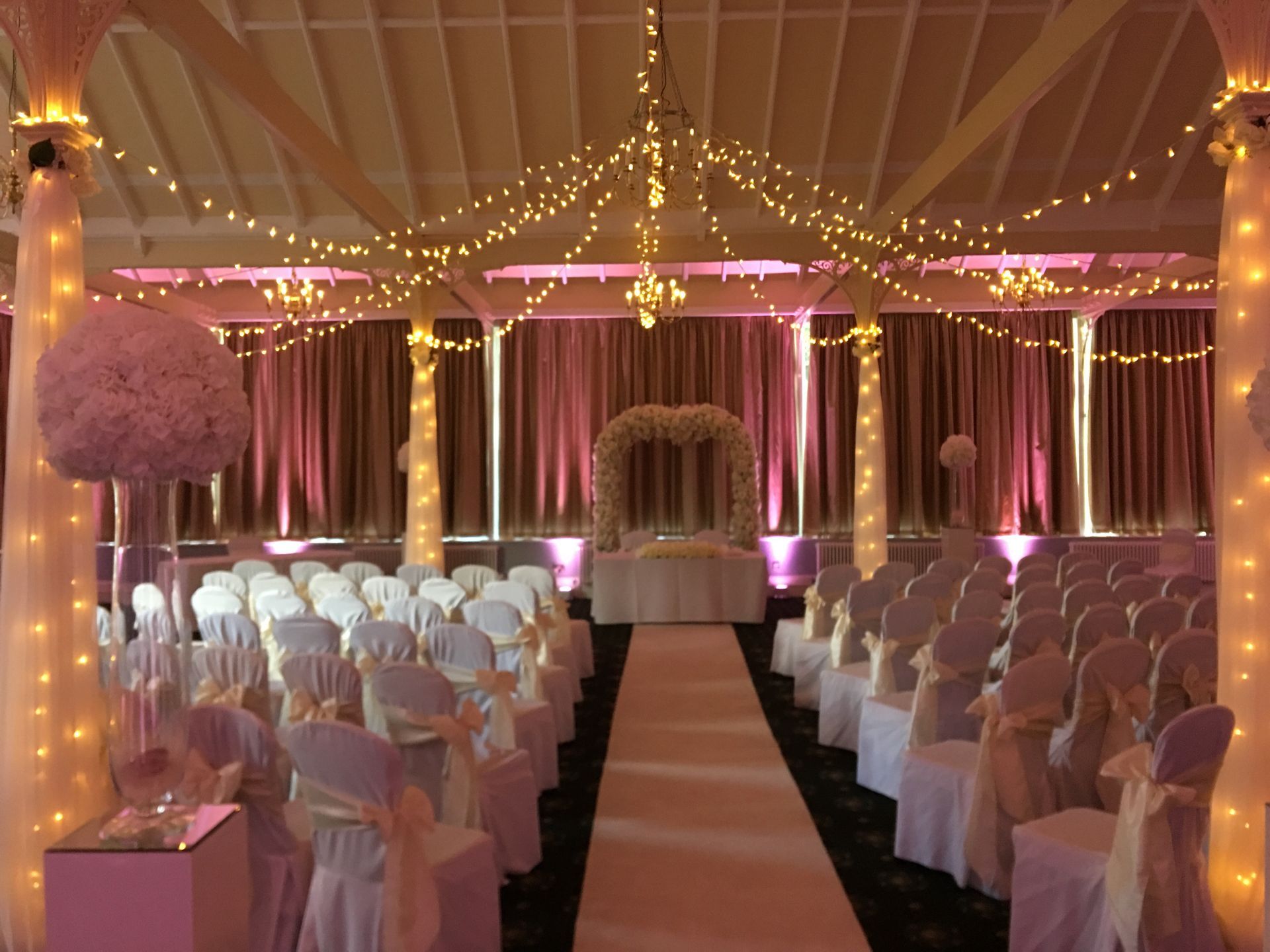 Wedding decor and lighting in soft pinks and warm white fairy lights, from Exclusive Entertainments.
