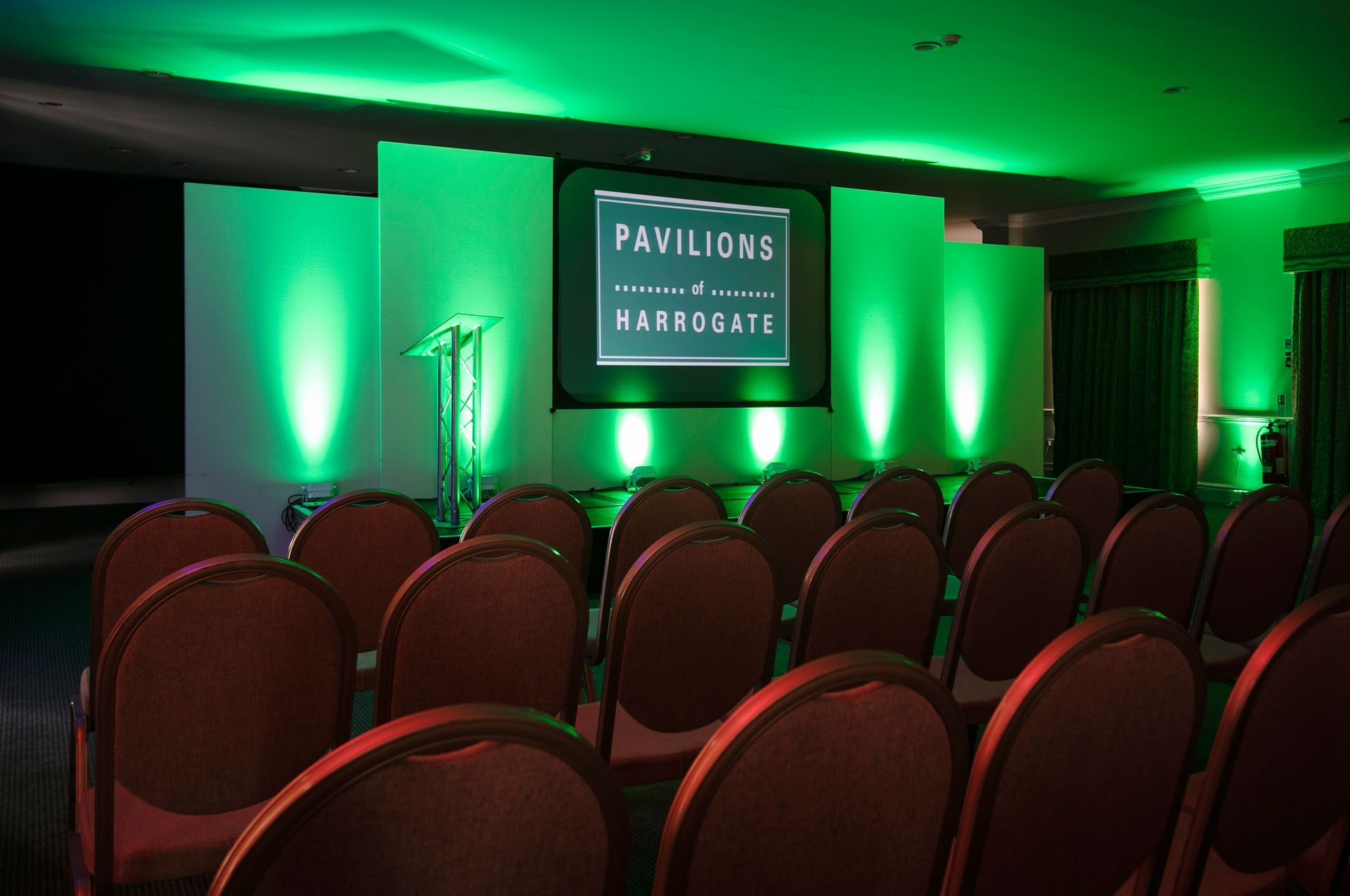 A corporate event, in the North of England with green uplighting on the stage the event production and equipment was hired from Exclusive Entertainment based in Yorkshire