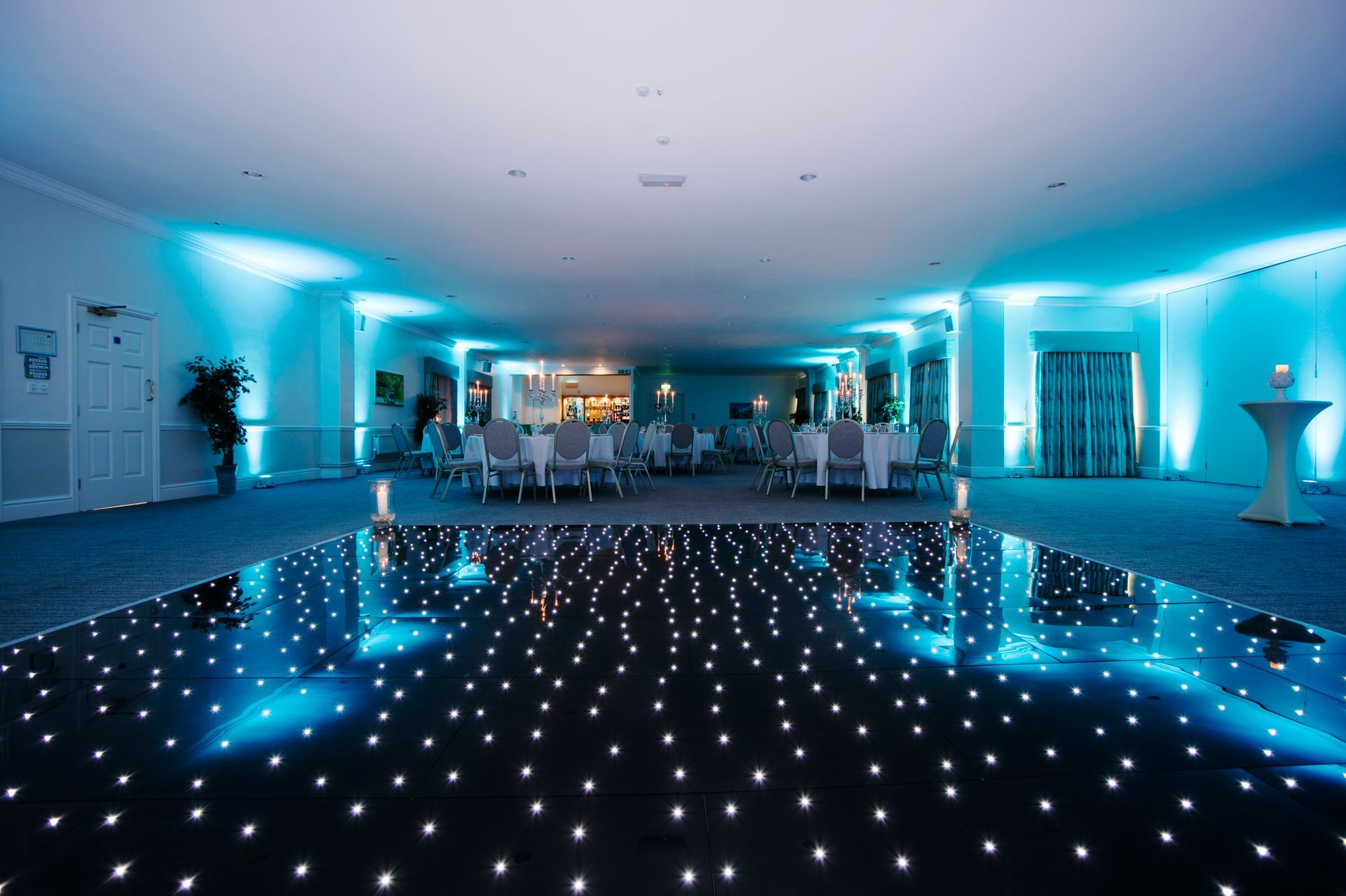 Decor and Lighting in cool whites and. blues surround a  hired light up dance floor. Production services and equipment  hire for this event was supplied by Exclusive Entertainments Harrogate,Yorkshire