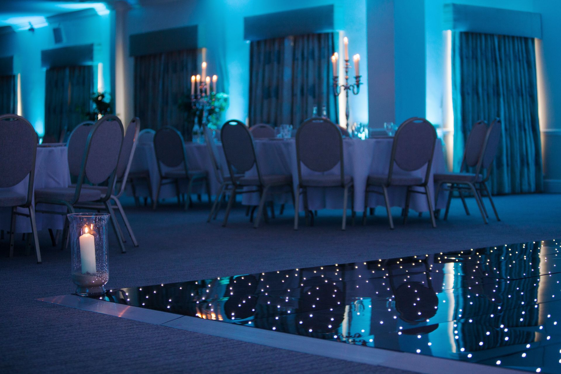 Decor and Lighting in cool whites and. blues surround a  hired LED dance floor. Production services and equipment  hire for this event was supplied by Exclusive Entertainments Harrogate,Yorkshire