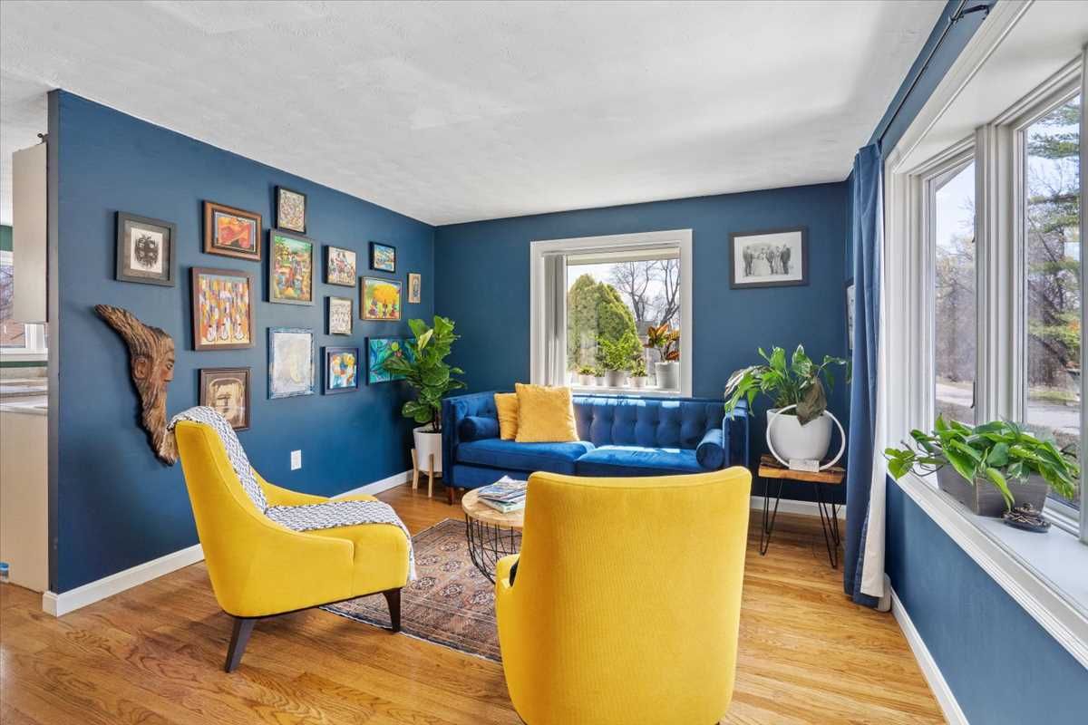 A living room with a couch , chair , table and rug.