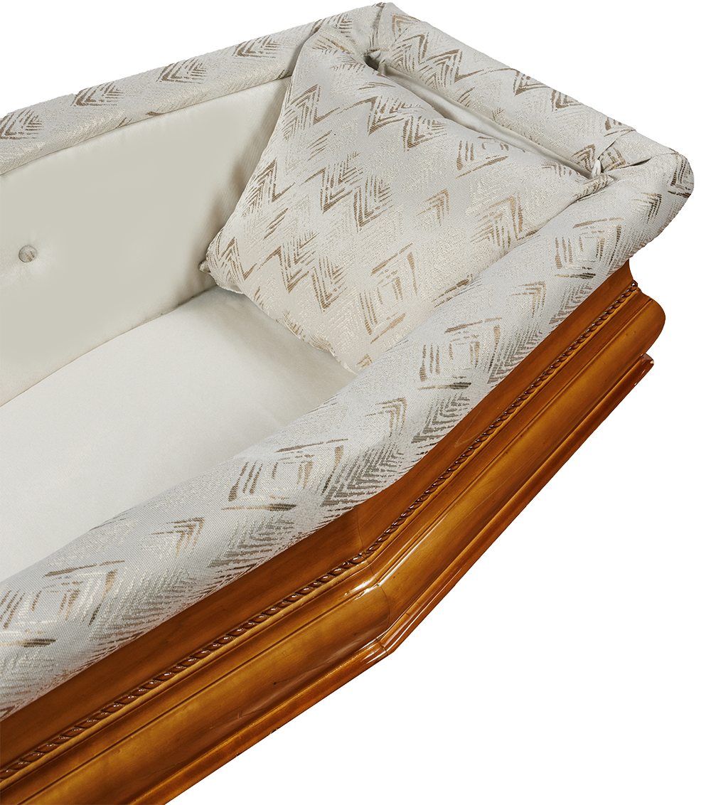 Interno di una bara di legno lucidato; biancheria da letto bianca e poggiatesta decorato.