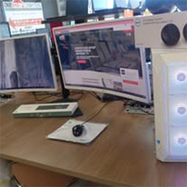 A desk with two computer monitors and a mouse on it