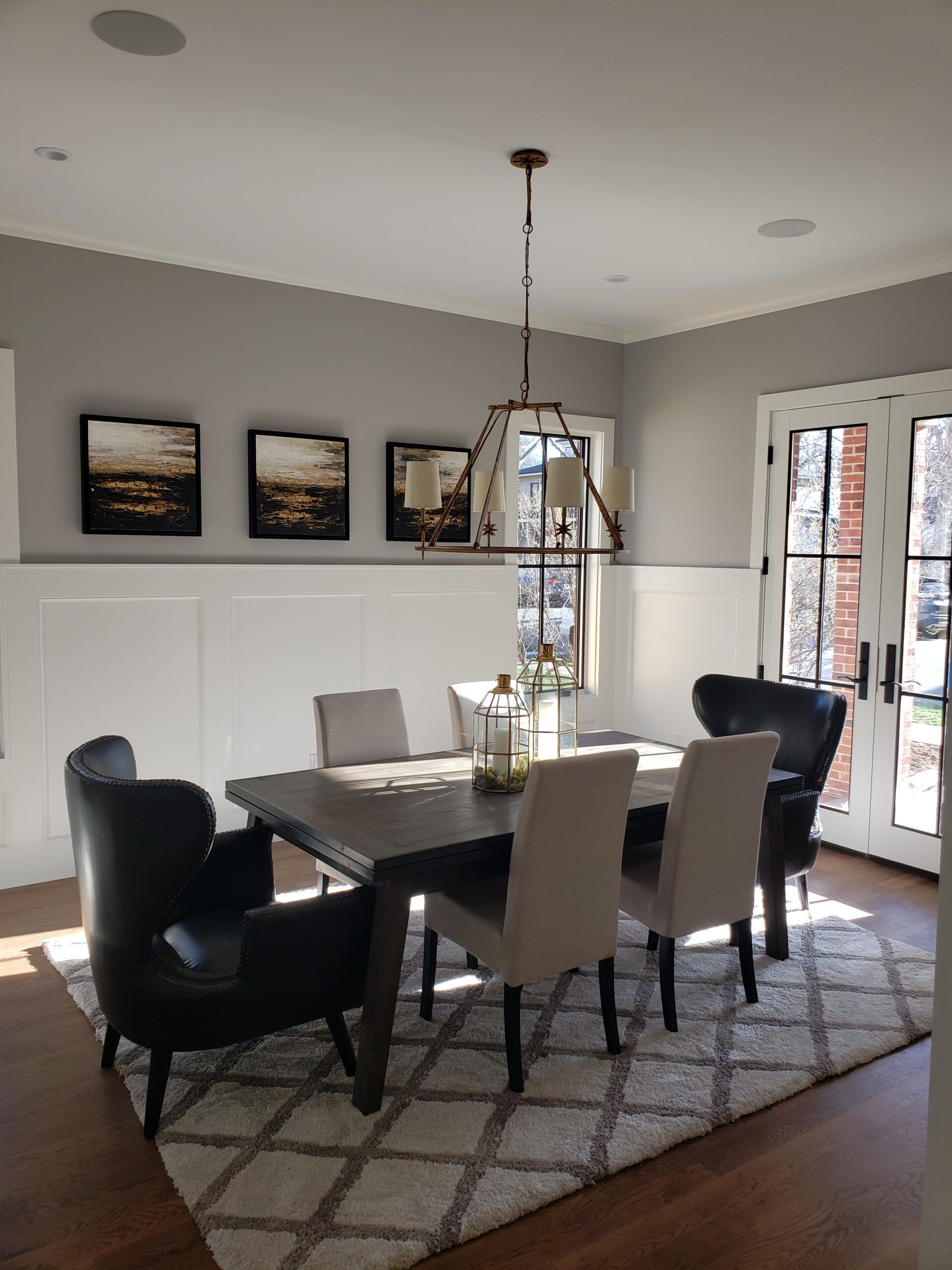 A dining room with a table and chairs and a rug