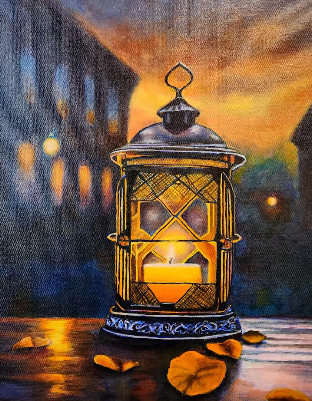 Lantern with lit candle on a table, autumn leaves, blurry buildings, and a sunset in the background.