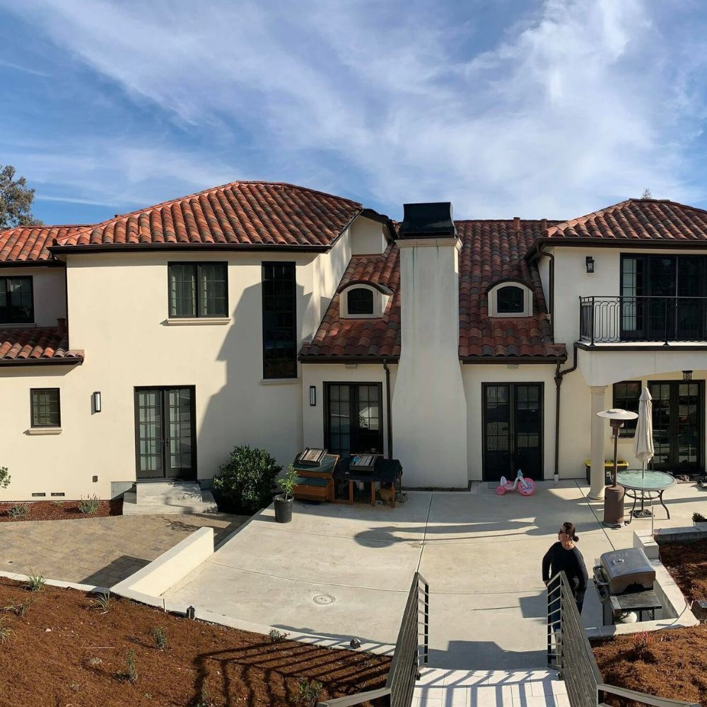 A large white house with a red tile roof