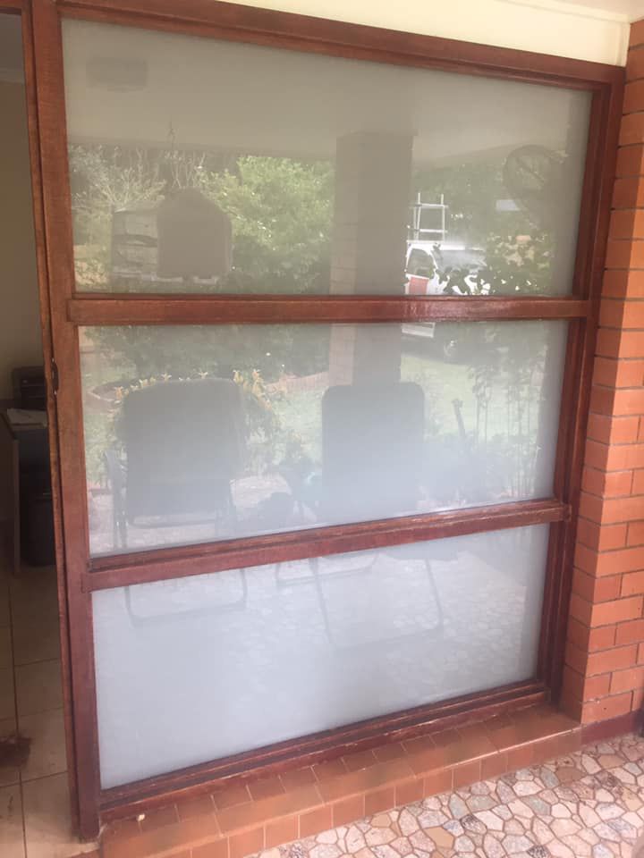 Stylish glass door complemented by a wooden frame — Cairns All Star Glass 'n' Aluminium in Bentley Park, QLD