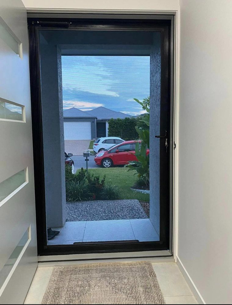 Residential mesh screen enhancing the functionality of the door — Cairns All Star Glass 'n' Aluminium in Bentley Park, QLD