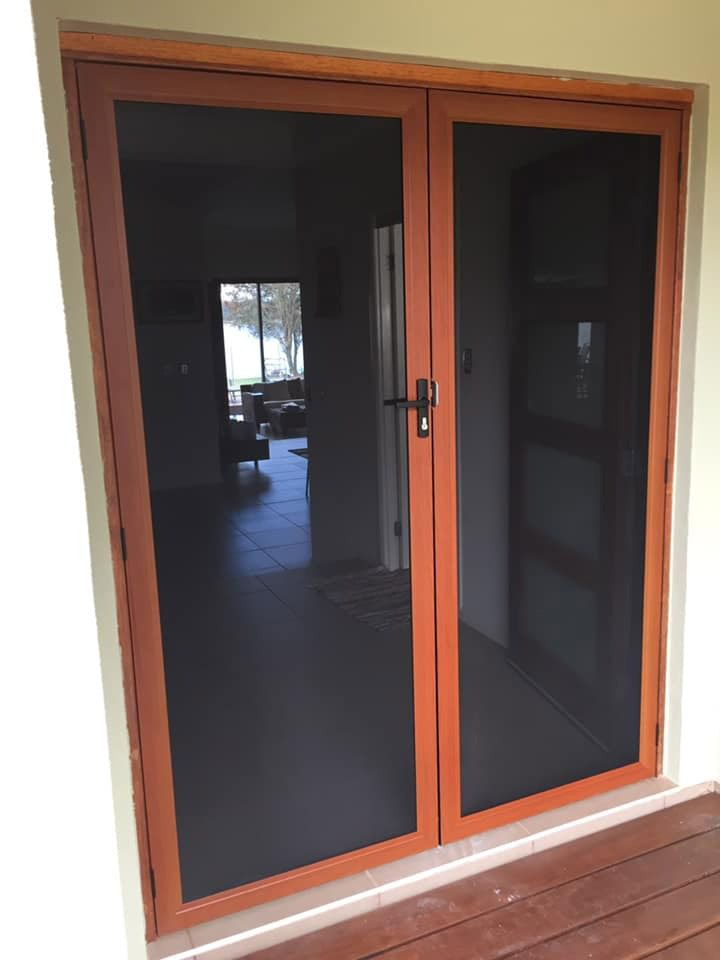 Secure glass door with a wooden frame, combining elegance and safety — Cairns All Star Glass 'n' Aluminium in Cassowary Coast, QLD
