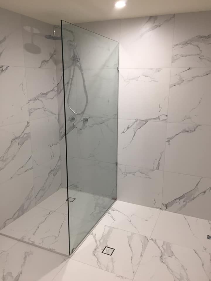 Modern bathroom featuring a sleek glass wall — Cairns All Star Glass 'n' Aluminium in Bentley Park, QLD