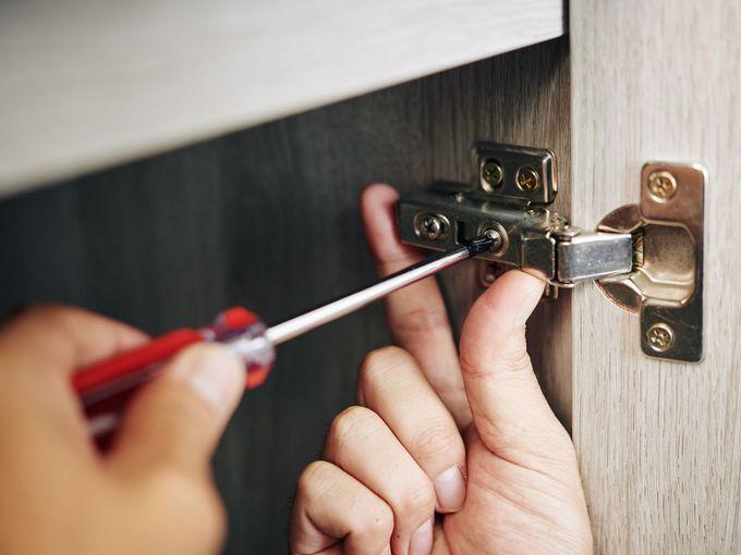 Photo of person using screw driver - Maintenance Request