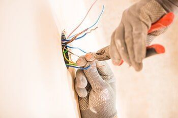 Worker fixing wires for light installation — Light Repair in Madison, MS