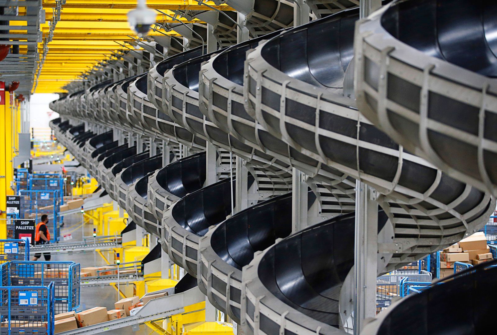 Spiral conveyor belts at a large warehouse sort packages. Amazon Distribution Center Spiral Chutes