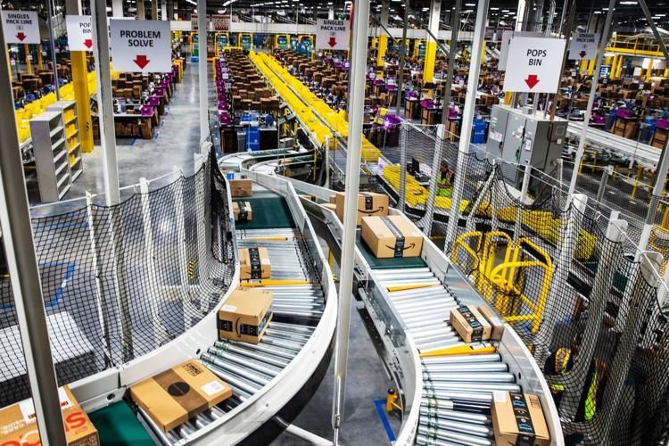 Conveyor belts transport boxes in a large warehouse. Yellow and white accents, labeled sections, industrial setting.