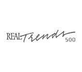 The logo for real trends 500 is a handwritten logo on a white background.