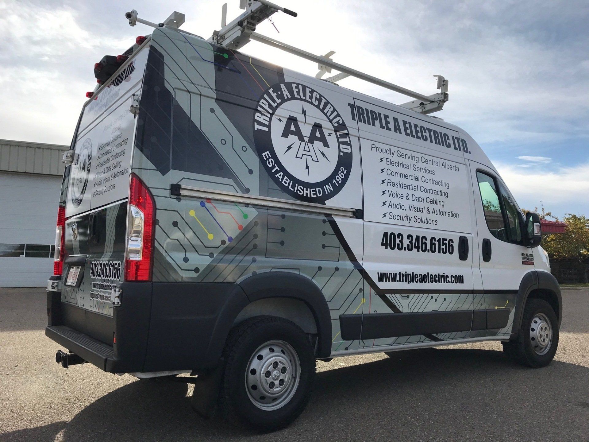 a white van is parked in front of a building .